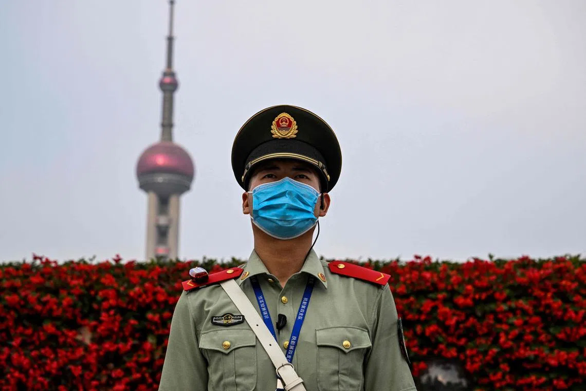 A Chinese paramilitary police stands guard next to the Bund promenade in Shanghai on June 15, 2023.