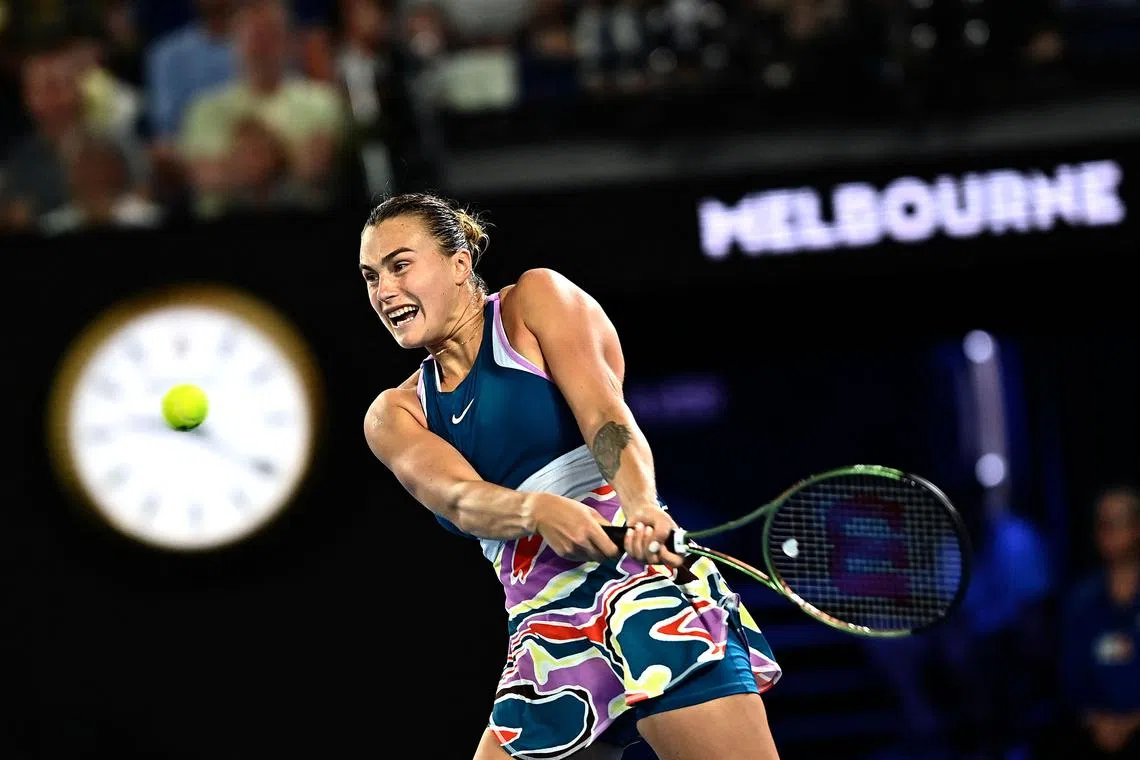 TOPSHOT - Belarus' Aryna Sabalenka hits a return against Kazakhstan's Elena Rybakina during their women's singles final match on day thirteen of the Australian Open tennis tournament in Melbourne on January 28, 2023. (Photo by MANAN VATSYAYANA / AFP) / -- IMAGE RESTRICTED TO EDITORIAL USE - STRICTLY NO COMMERCIAL USE --