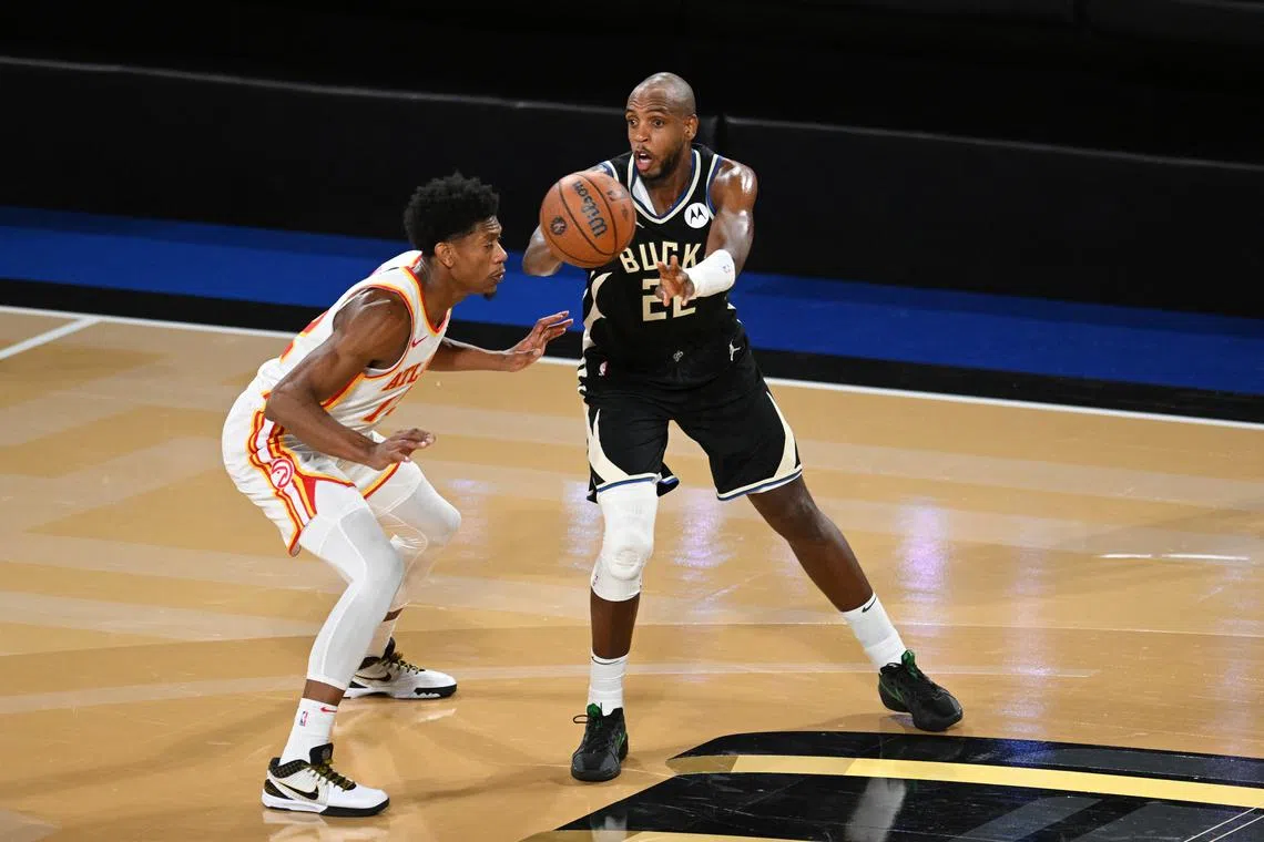 Dec 14, 2024; Las Vegas, Nevada, USA; Milwaukee Bucks forward Khris Middleton (22) passes against Atlanta Hawks forward De'Andre Hunter (12) during the fourth quarter in a semifinal of the 2024 Emirates NBA Cup at T-Mobile Arena. Candice Ward-Imagn Images/File Photo