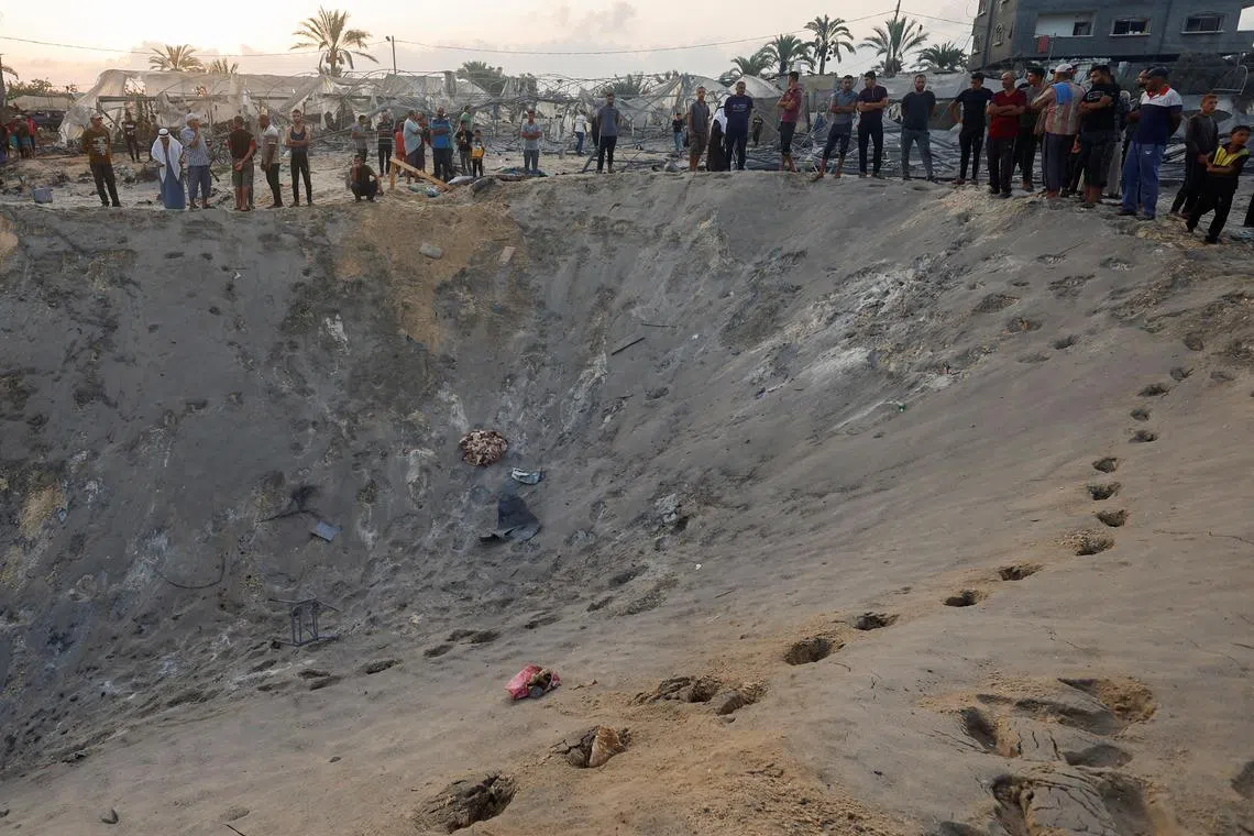 Palestinians on Sept 10 inspect the site following Israeli strikes on a tent camp sheltering displaced people at the Al-Mawasi area in Khan Younis in the southern Gaza Strip.
