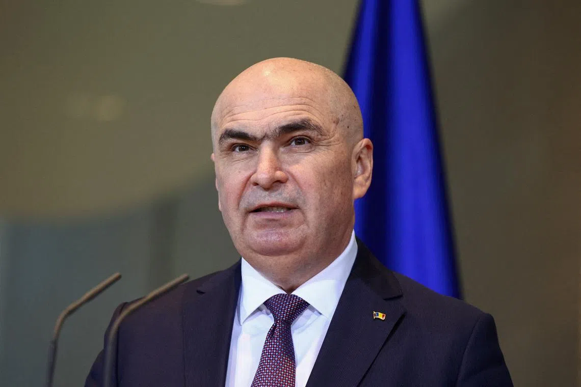 FILE PHOTO: Romanian Prime Minister Ilie Bolojan holds a press conference with German Chancellor Friedrich Merz (not pictured), at the Chancellery, in Berlin, Germany, January 28, 2026. REUTERS/Liesa Johannssen/File Photo