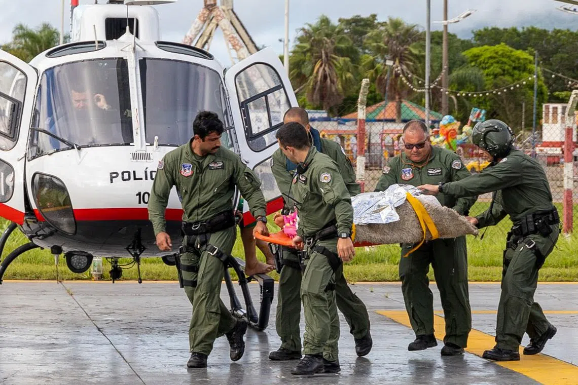 Military police helping flood victims in the municipality of sao Sebastiao, north coast of the state of Sao Paulo, Brazil, on Feb 19.