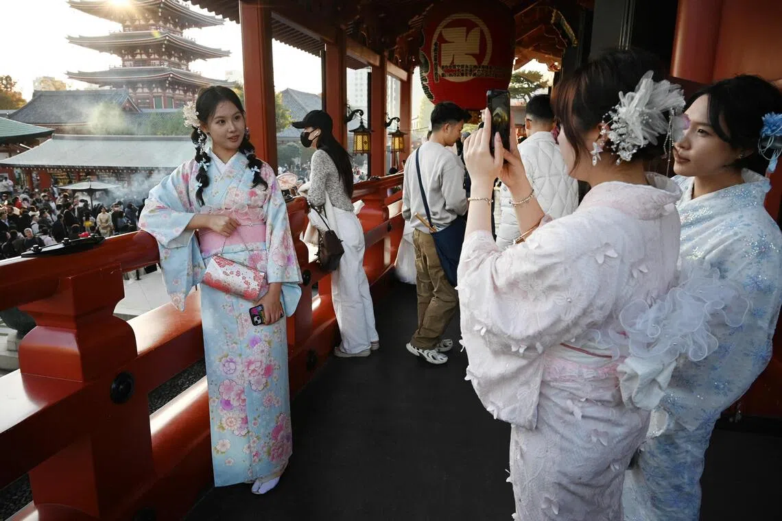 Chinese tourists wear kimonos as they visit the Sensoji Temple in the Asakusa district of Tokyo on Nov 15.