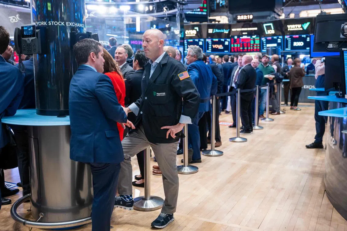 Traders work on the floor of the New York Stock Exchange, in New York City.
