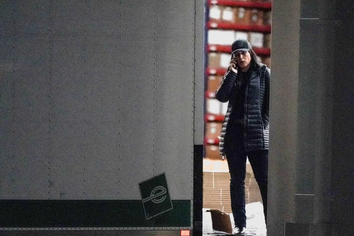 United States Director of National Intelligence Tulsi Gabbard speaks on the phone while standing at the edge of a truck loading bay after the Federal Bureau of Investigation (FBI) executed a search warrant for the Fulton County Election Hub and Operation Center in relation to the 2020 election, according to a law enforcement official familiar with the matter, in Union City, Georgia, U.S. January 28, 2026.  REUTERS/Elijah Nouvelage.