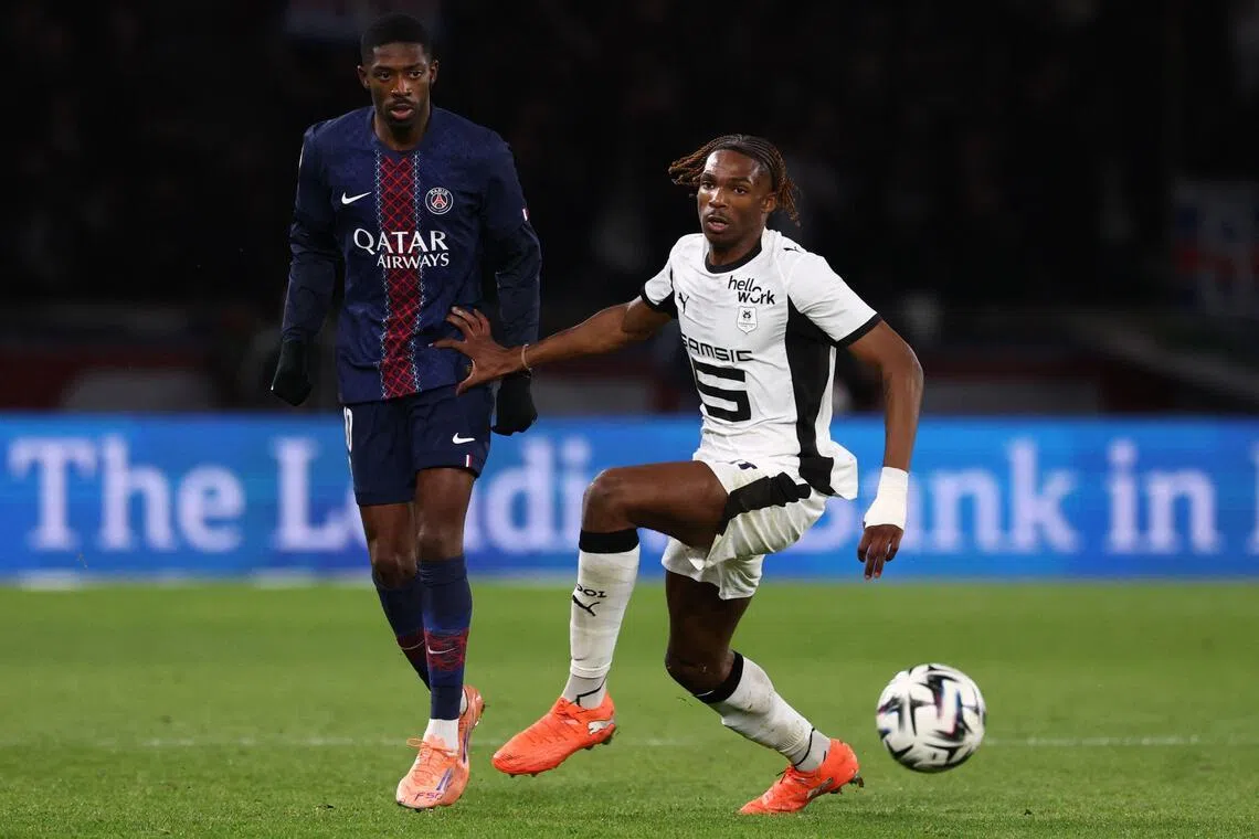 Paris Saint-Germain's French forward Ousmane Dembele (left) and Rennes' French defender Jeremy Jacquet fighting for the ball during a Ligue 1 football match at the Parc des Princes stadium in Paris on Dec 6, 2025. Jacquet looks set to join Liverpool.