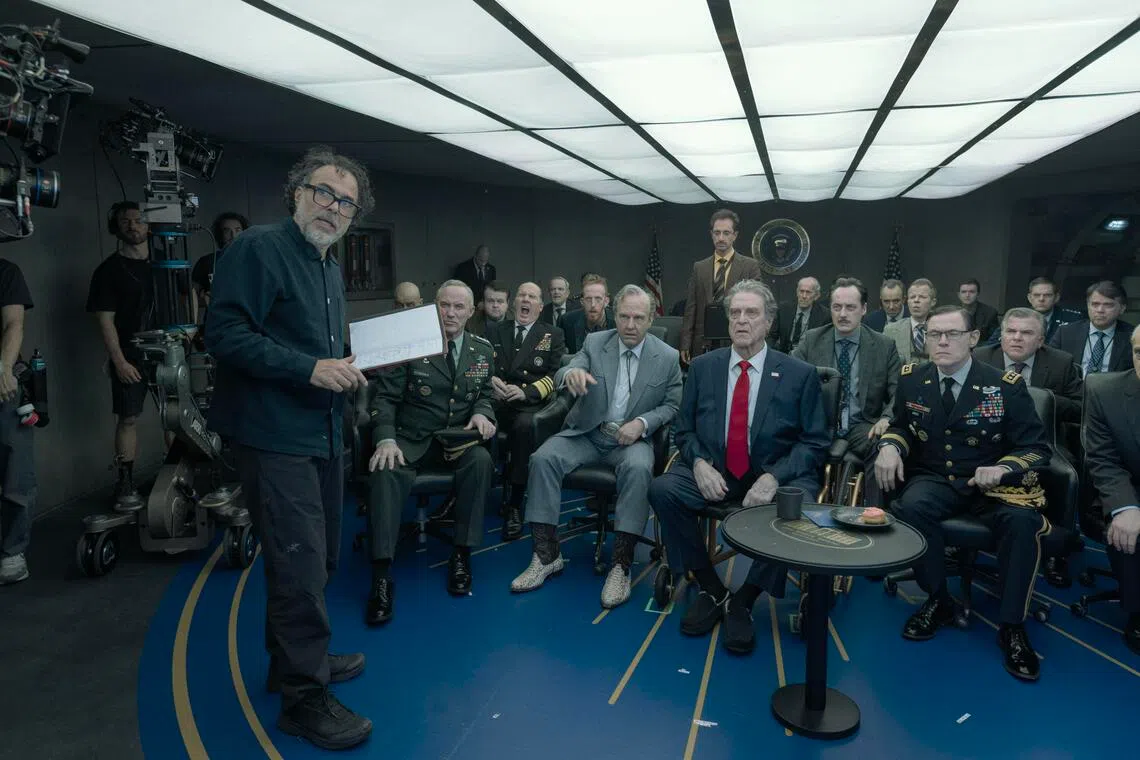 Director Alejandro Gonzalez Inarritu (left) with actors Tom Cruise (seated centre in grey suit) and John Goodman (with red tie) on the set of Digger.