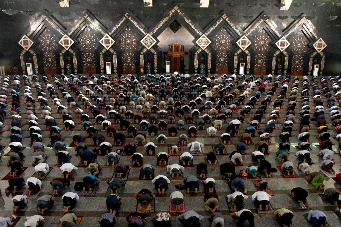 People offer congregational Friday prayers at the Attin Mosque in Jakarta on June 5, 2020.