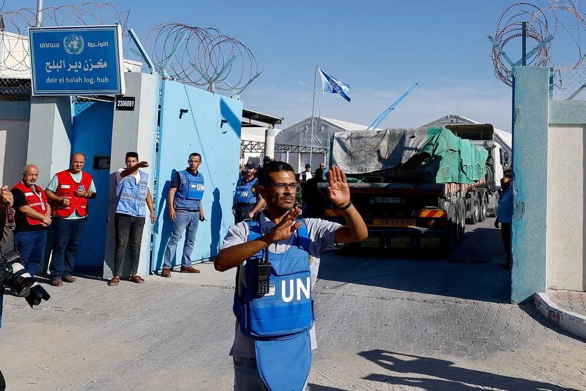 FILE PHOTO: Aid trucks arrive at a UN storage facility as the conflict between Israel and Palestinian Islamist group Hamas continues, in the central Gaza Strip October 21, 2023. REUTERS/Mohammed Salem/File Photo