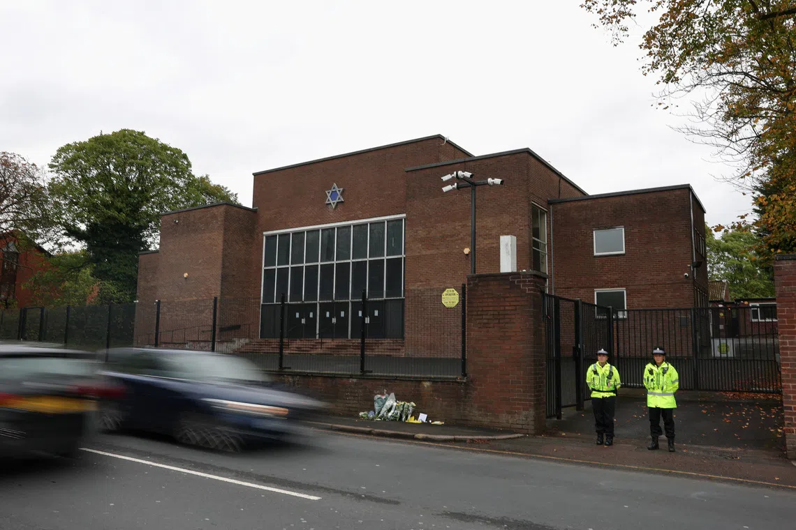 Police officers stand outside the Manchester synagogue, where multiple people were killed on Yom Kippur, in what police have declared a terrorist incident, in north Manchester, Britain, October 6, 2025. REUTERS/Hannah McKay