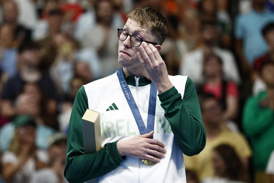 An emotional Daniel Wiffen reacts on the podium after becoming the first Irishman to win an Olympic swimming medal.