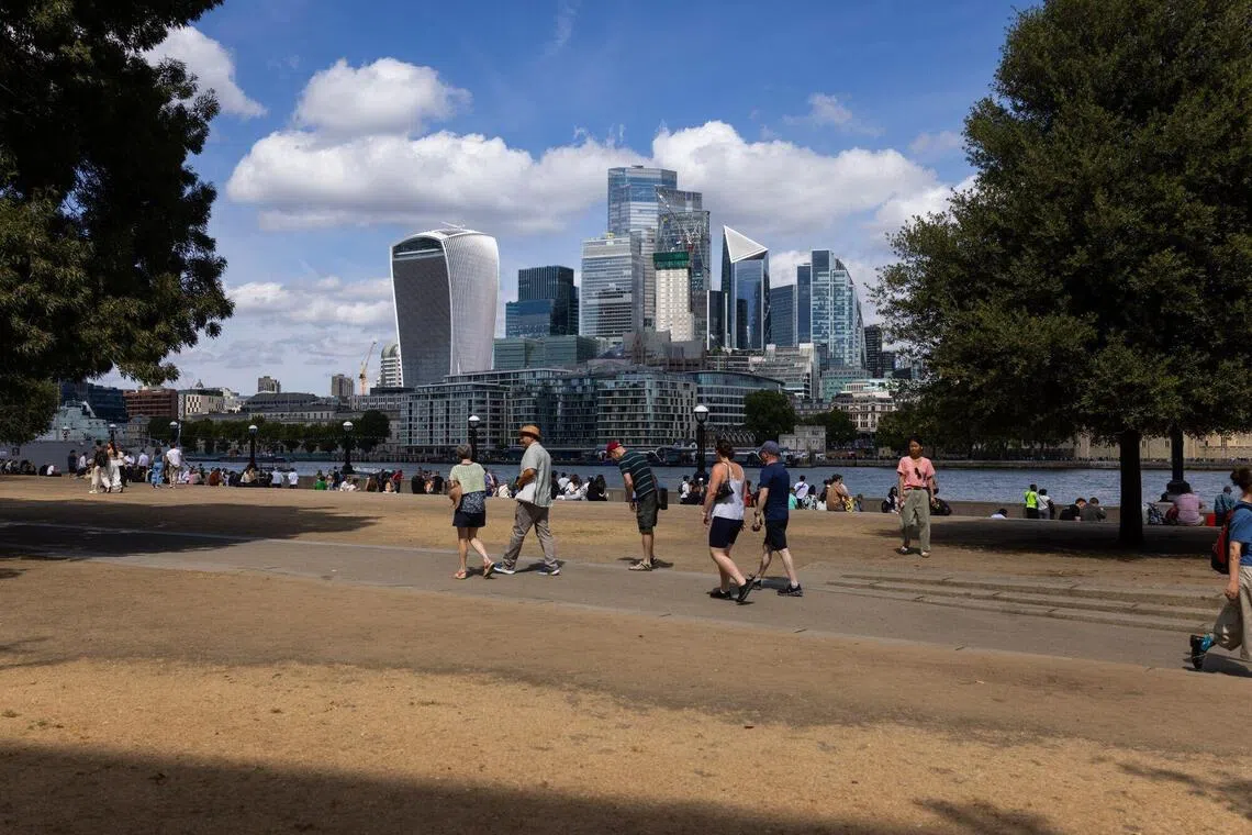 Dried out grass by the River Thames in London on Aug 10. Parks and fields that are usually green at this point in the year are parched and yellow amid a drought in England.
