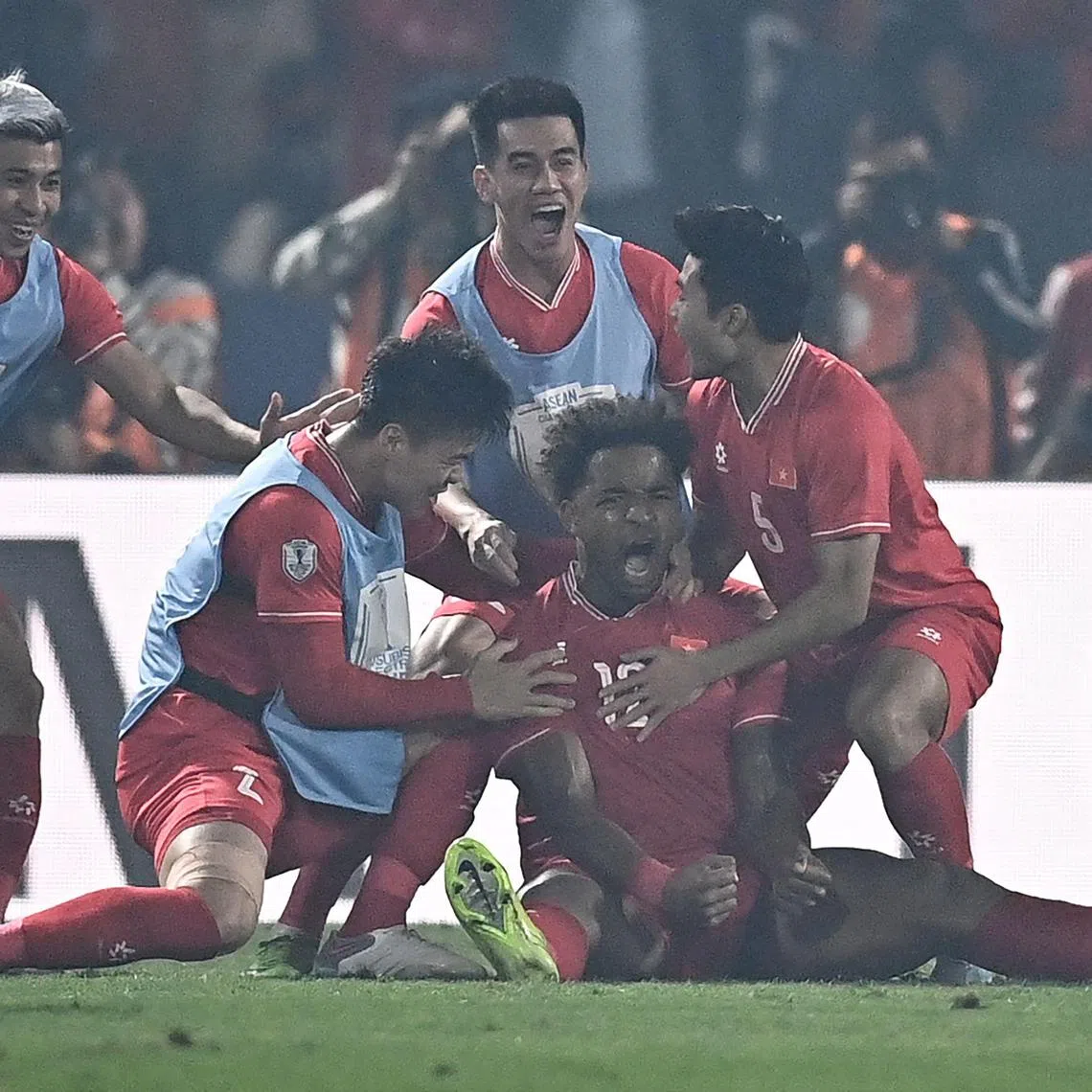 Vietnam's forward Rafaelson celebrating with teammates after scoring a goal during the 2-1 Asean Championship final, first -leg win over Thailand at the Viet Tri Stadium in Phu Tho province on Jan 2.