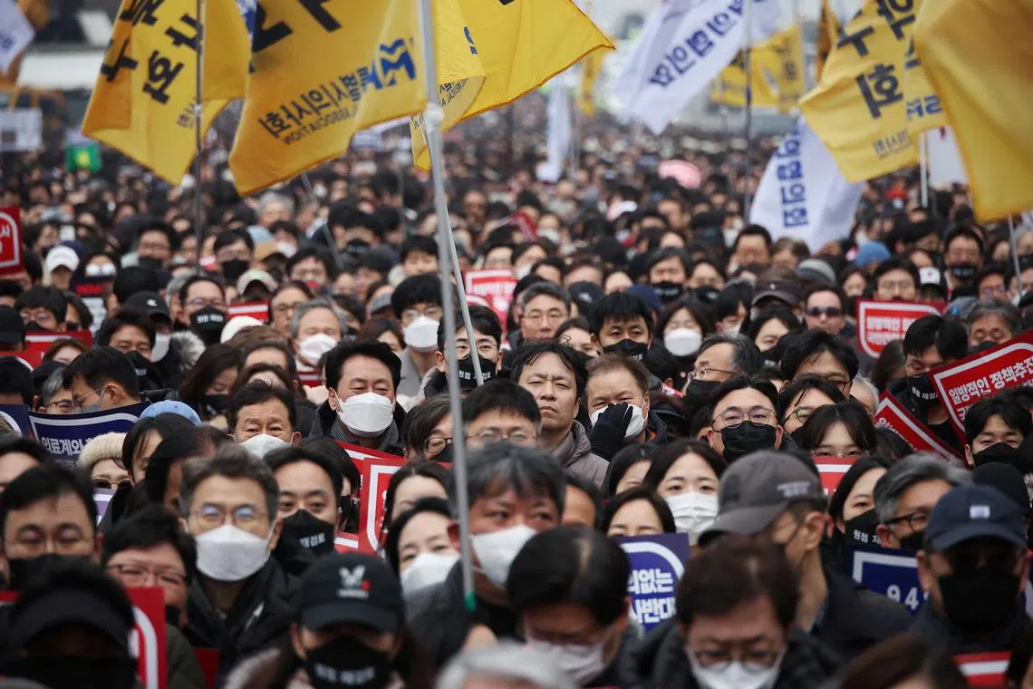 FILE PHOTO: Doctors take part in a rally to protest against government plans to increase medical school admissions in Seoul, South Korea, March 3, 2024.   REUTERS/Kim Hong-Ji/File Photo