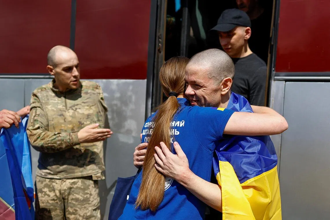 Ukrainian prisoners of war are welcomed home at an undisclosed location in Ukraine on Aug 19.