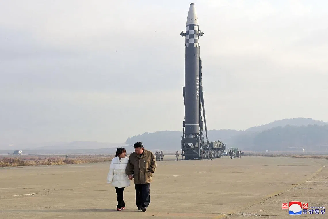 This picture taken on November 18, 2022 and released from North Korea's official Korean Central News Agency (KCNA) on November 19, 2022 shows North Korea's leader Kim Jong Un (R) walking with his daughter as he inspects a new intercontinental ballistic missile (ICBM) "Hwasong Gun 17", at Pyongyang International Airport. - North Korean leader Kim Jong Un said he would respond to US threats with nuclear weapons, state media said on November 19, after Kim personally oversaw Pyongyang's latest launch of intercontinental ballistic missile. (Photo by KCNA VIA KNS / AFP) / South Korea OUT / REPUBLIC OF KOREA OUT
---EDITORS NOTE--- RESTRICTED TO EDITORIAL USE - MANDATORY CREDIT "AFP PHOTO/KCNA VIA KNS" - NO MARKETING NO ADVERTISING CAMPAIGNS - DISTRIBUTED AS A SERVICE TO CLIENTS / THIS PICTURE WAS MADE AVAILABLE BY A THIRD PARTY. AFP CAN NOT INDEPENDENTLY VERIFY THE AUTHENTICITY, LOCATION, DATE AND CONTENT OF THIS IMAGE --- / 