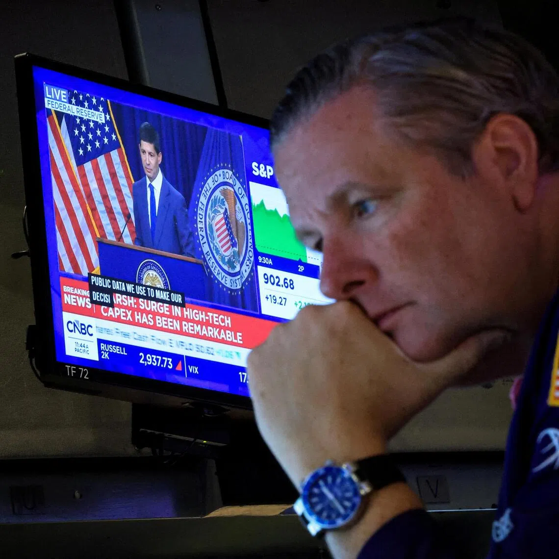 A trader working at the New York Stock Exchange on July 29, as a screen broadcasts a press conference by US Federal Reserve chairman Kevin Warsh following the Fed’s latest rate announcement.