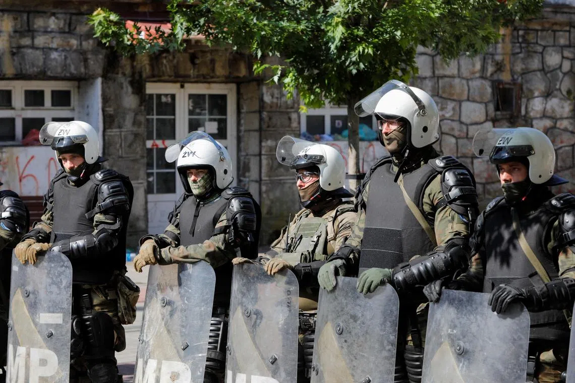 Polish Kosovo Force (KFOR) soldiers stand guard at a municipal office in Zvecan, Kosovo on May 30, 2023. 