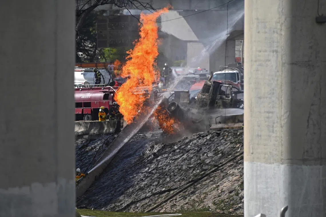 Mexican firefighters extinguish the flames of a gas truck that exploded in Mexico City on Sept 10, 2025. 
