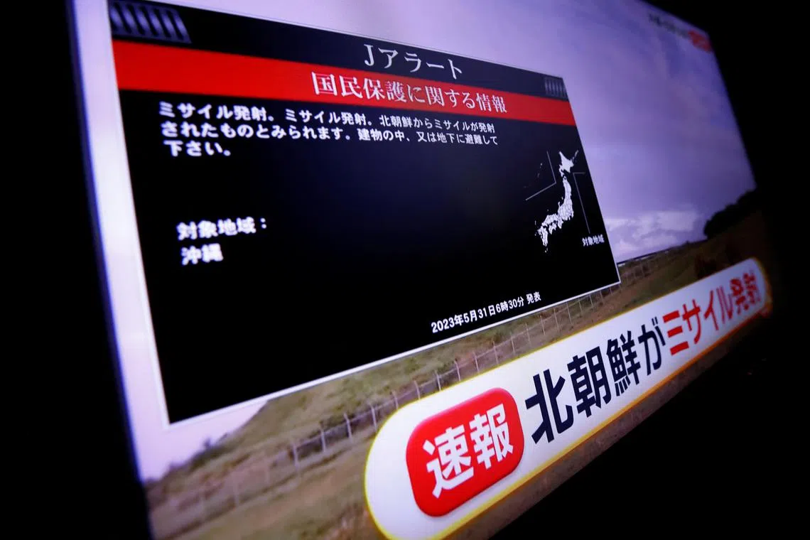 A TV screen displays a warning message called "J-alert" after the Japanese government issued an emergency on May 31.