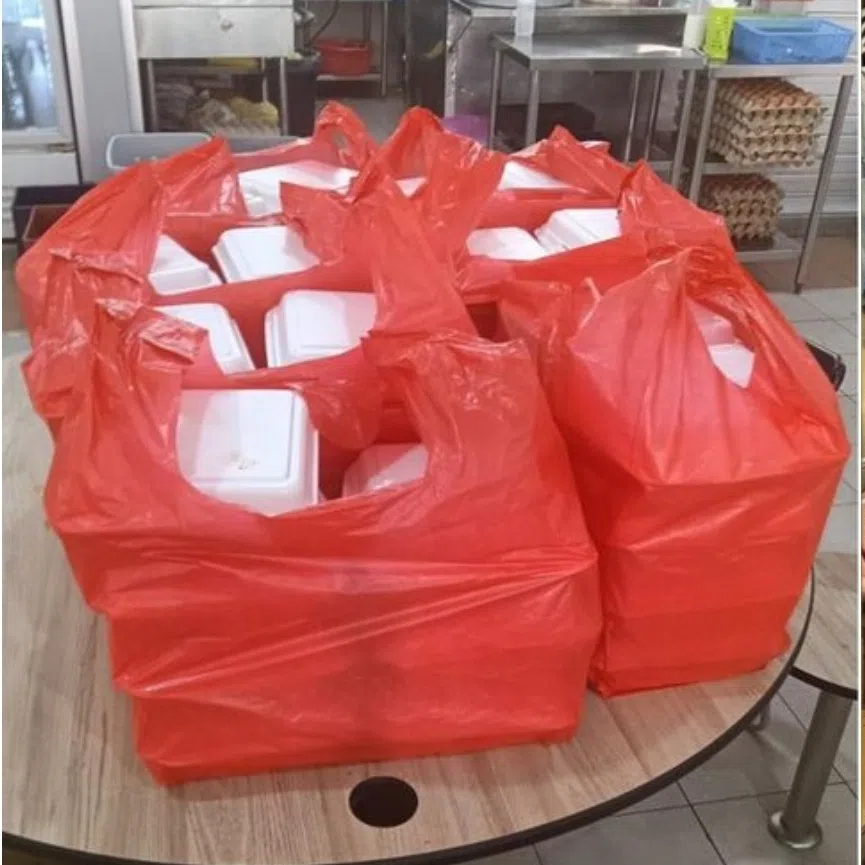 A hawker stall in Tiong Bahru Market (left) was scammed with a fake order of 150 packets of briyani and Kiki Florist was scammed with a huge order of 150 small bouquets and four extra-large bouquets.