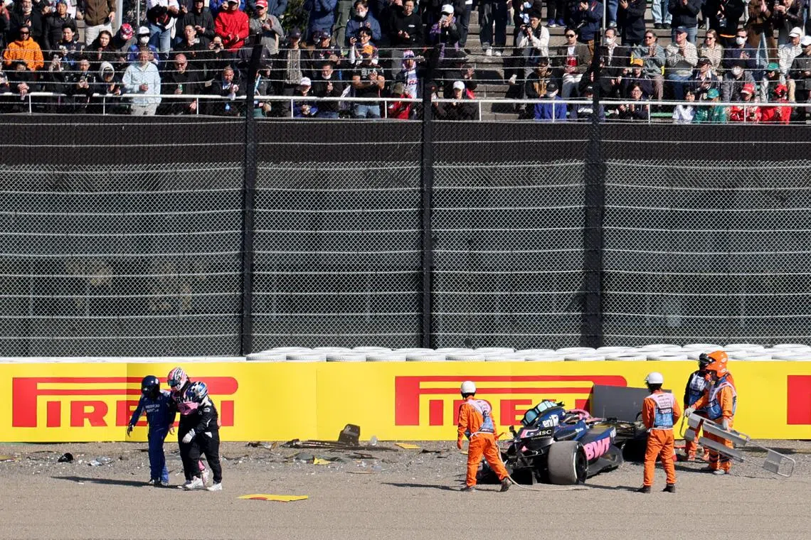Formula One F1 - Japanese Grand Prix - Suzuka Circuit, Suzuka, Japan - April 4, 2025 Alpine's Jack Doohan walks away with a medical team as marshals attend his car after the crashing during practice REUTERS/Issei Kato
