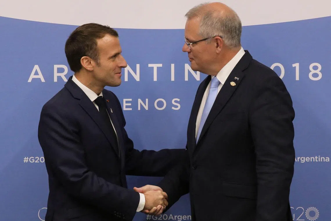 Mr Scott Morrison (right) revealed new details of how he kept French President Emmanuel Macron in the dark about Australia's nuclear submarine deal with the US and UK.