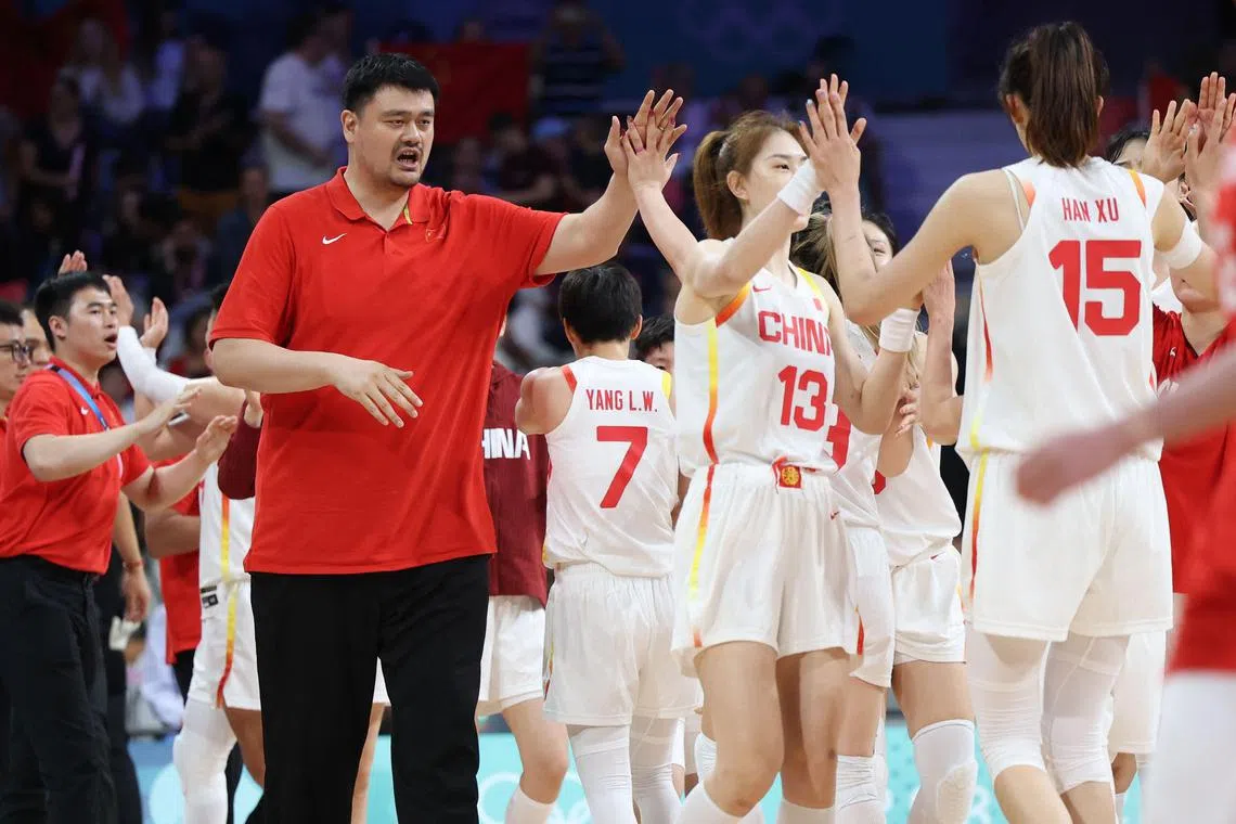 Yao Ming celebrating with the Chinese women's basketball team after they beat  Puerto Rico in a Paris Olympic Games group game in August 2024.