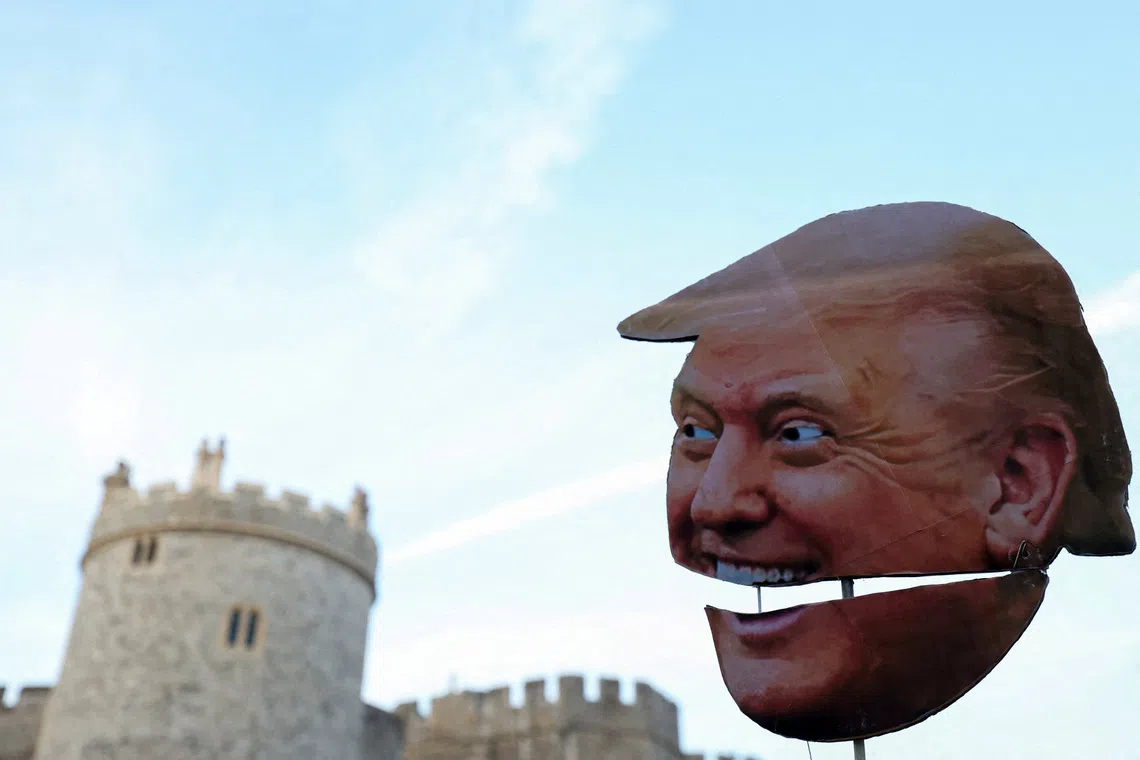 A cardboard cutout depicting U.S. President Donald Trump's face is held up during a "Trump Not Welcome" protest ahead of U.S. President Donald Trump and first lady Melania Trump's arrival for their state visit to the country, in Windsor, Britain on Sept 16, 2025. 