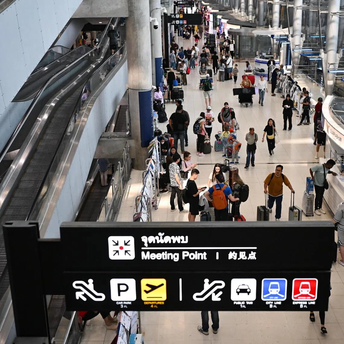 Passengers in the arrival hall of Suvarnabhumi Airport in Bangkok, Thailand.