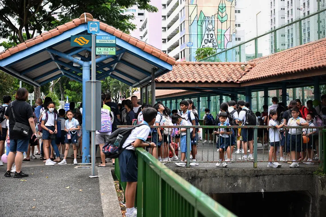 Generic pix of students from Xinmin Primary School waiting at a bus stop after school dismissal on Sept 22, 2023.