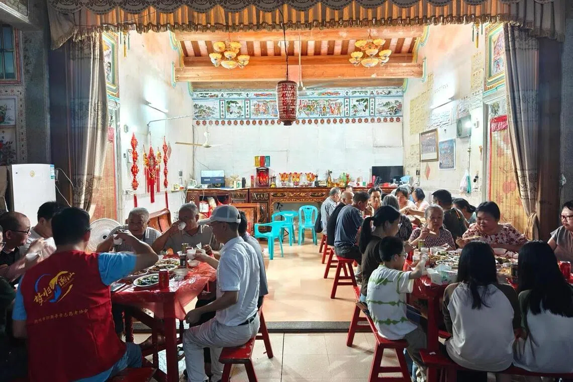 The Chews hosting a lavish meal in their ancestral village of Xiwei for the newfound Singaporean family.