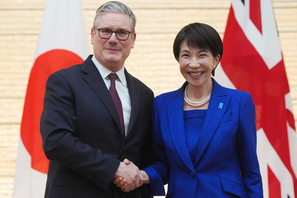 British Prime Minister Keir Starmer (L) and Japanese Prime Minister Sanae Takaichi shake hands after their joint press conference following their bilateral meeting at the Prime Minister's Office in Tokyo on January 31, 2026. (Photo by Carl Court / POOL / AFP)