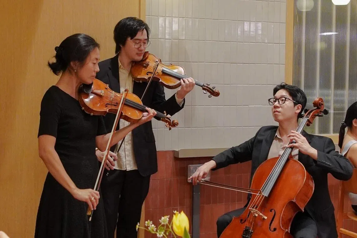 (From left) Serenading the guests at dinner are a string trio consisting of violinists Tang Tee Khoon and Yang Shuxiang, as well as cellist Hang Oh Cho. 