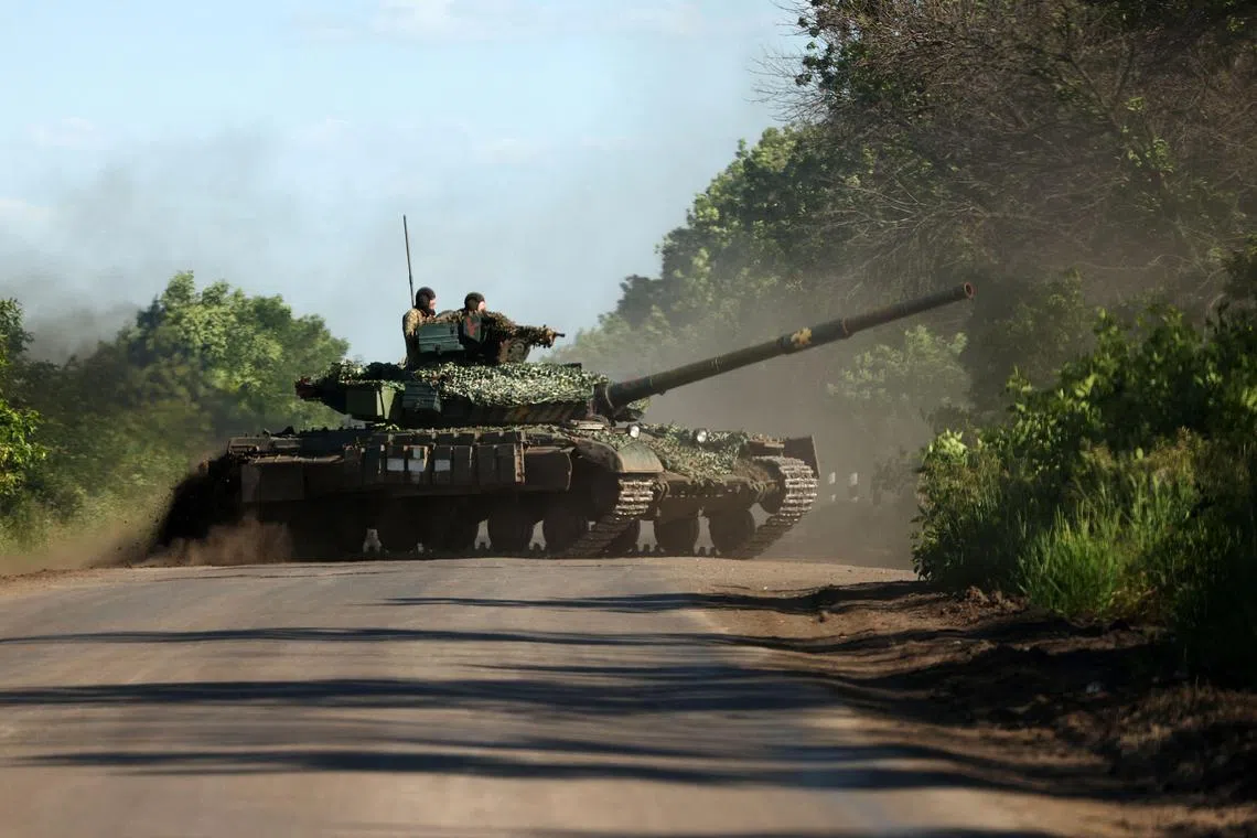 Ukrainian servicemen drive a tank on a road near the front line, in the Donetsk region of Ukraine.