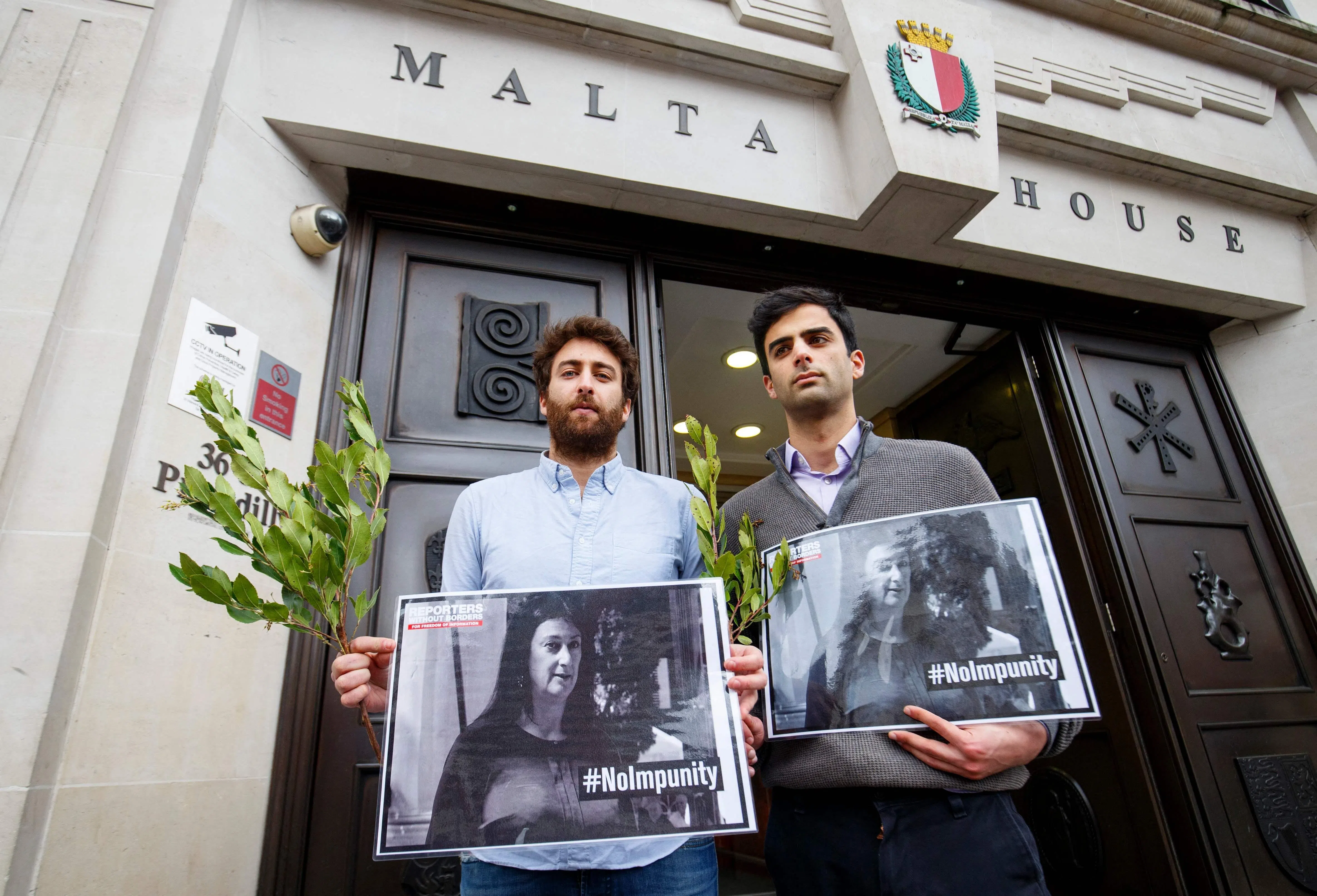 (FILES) Matthew Caruana Galizia (L) and Paul Caruana Galizia, the sons of murdered Maltese journalist Daphne Caruana Galizia, attend a vigil outside the Maltese High Commission in London on April 16, 2018, six months after she was assasinated. The man accused of ordering the 2017 murder of a hard-hitting investigative journalist in Malta finally faced a court on July 1, 2026, marking a key moment in the criminal case that rocked the tiny nation. Businessman Yorgen Fenech is charged with orchestrating the assasination of Daphne Caruana Galizia, 53, a prominent public figure and vocal critic who was killed by a bomb placed in her car near her home. (Photo by Tolga AKMEN / AFP)