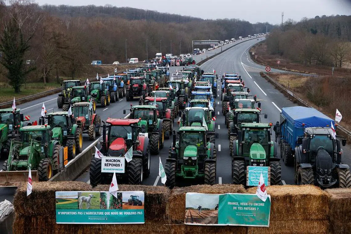 French farmers block a highway with their tractors during a protest over price pressures, taxes and green regulation, grievances shared by farmers across Europe, in Longvilliers, near Paris, France, January 30, 2024. REUTERS/Abdul Saboor
