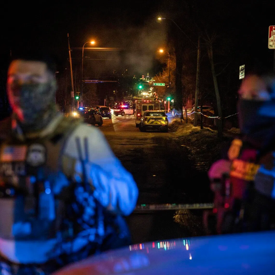 Federal agents near the scene where a federal agent shot a man from Venezuela while trying to detain him in Minneapolis, on Jan 14.