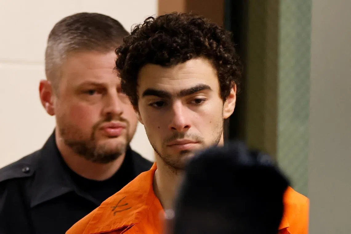 Luigi Mangione, 26, a suspect in the New York City killing of UnitedHealth executive Brian Thompson, is escorted after an extradition hearing at Blair County Court House in Hollidaysburg, Pennsylvania, U.S. December 10, 2024.   REUTERS/Eduardo Munoz/File Photo