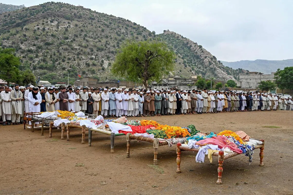 TPeople offering prayers during the funeral ceremony of victims who died in flash floods at Darra Adamkhel in Khyber Pakhtunkhwa province of Pakistan, on July 30, 2024. 
