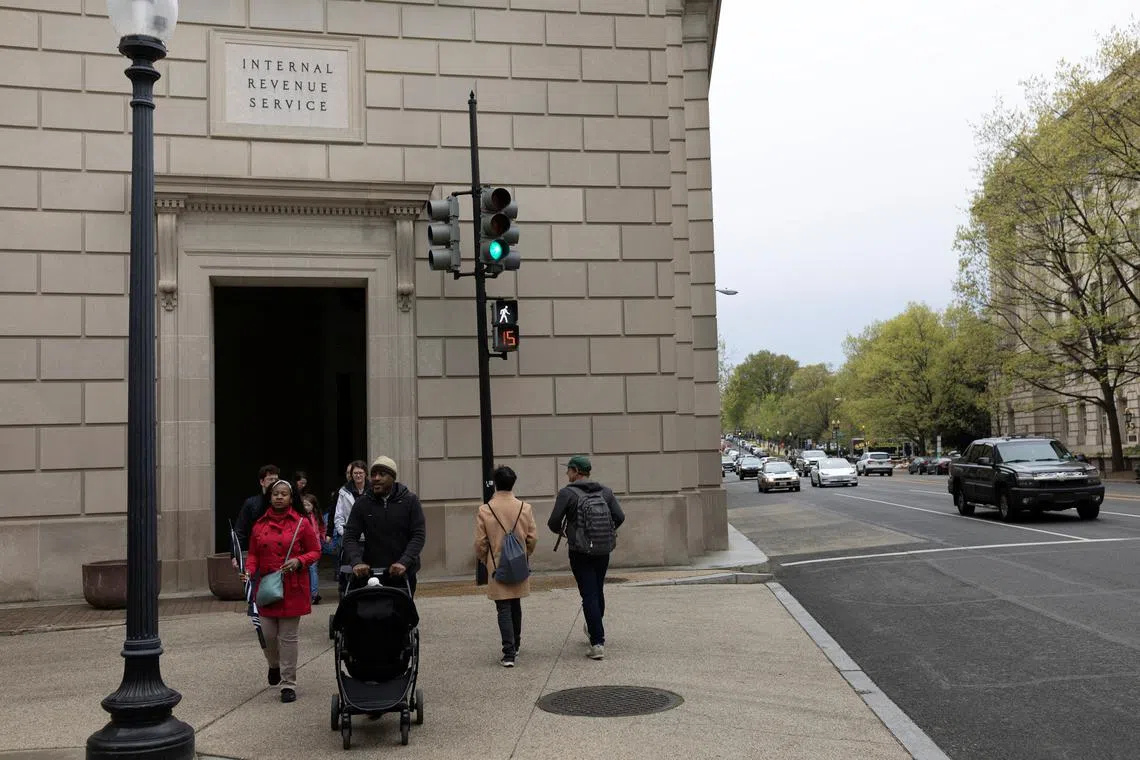 People walk past an entrance to the U.S. Internal Revenue Service building in Washington, U.S, April 7, 2023. REUTERS/Tom Brenner/File Photo
