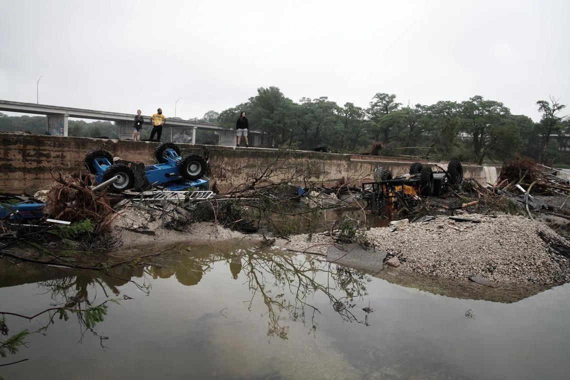 People oberving the damage from floodwaters in Kerrville, Texas, on July 5. 