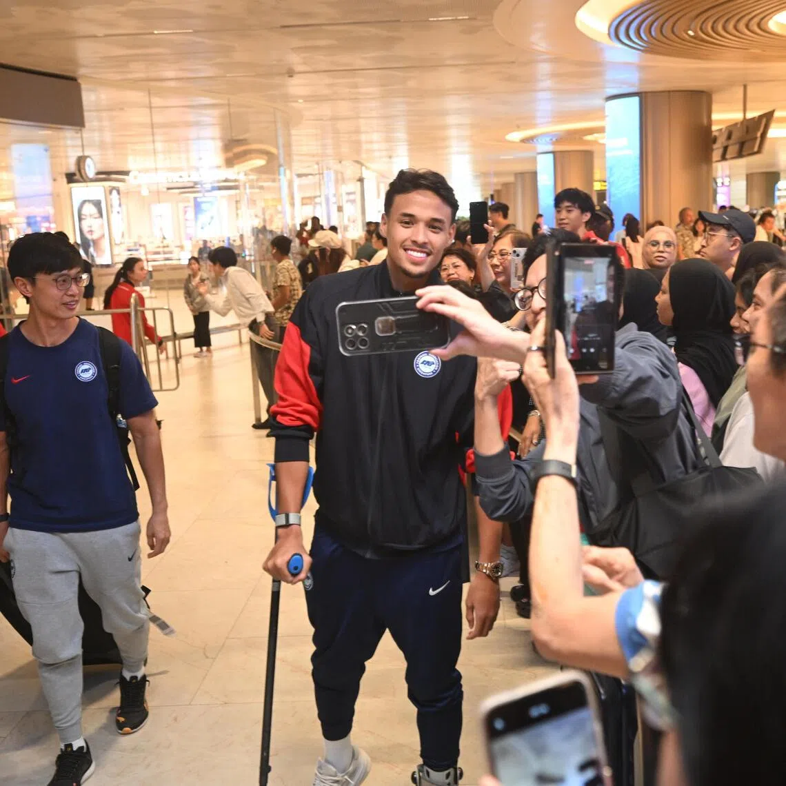 Ilhan Fandi arriving at Changi Airport with the Lions on Nov 19 after securing historic Asian Cup qualification in Hong Kong. 