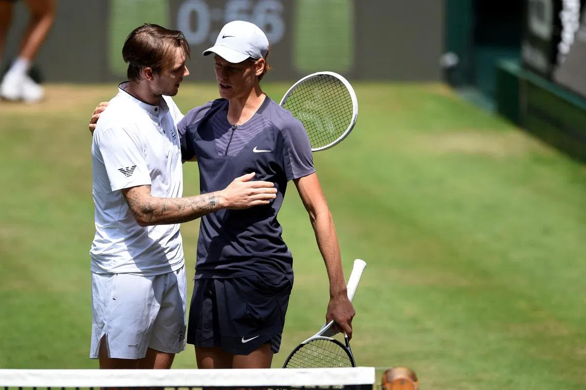 Italy's Jannik Sinner (right) and Kazakhstan's Alexander Bublik exchange words of encouragement after Sinner retired in their Halle Open quarter-final.