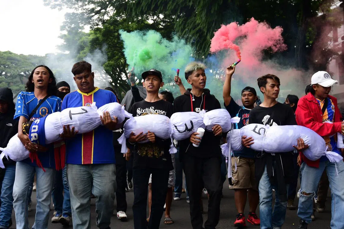 Football fans take part in a rally in front of the city hall in Malang on Oct 26, 2022, demanding for fair, transparent and indiscriminate law enforcement following the deadly stampede at Kanjuruhan stadium on Oct 1 that killed 135 people. 
