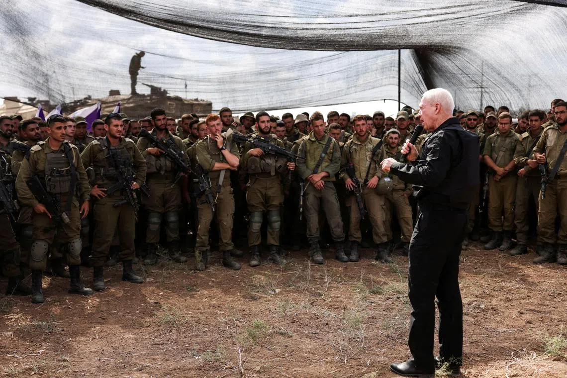 Israel's Defence Minister Yoav Gallant meets soldiers in a field near Israel's border with the Gaza Strip.