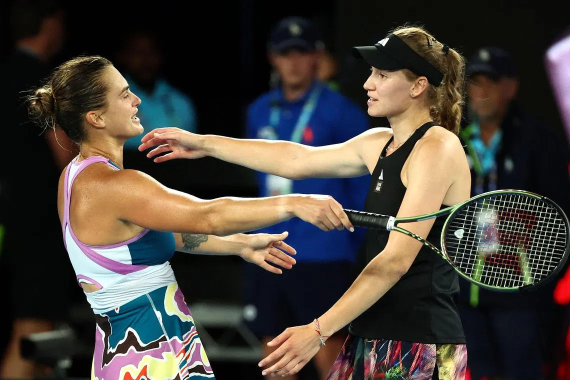 Belarus' Aryna Sabalenka (L) embraces Kazakhstan's Elena Rybakina after their women's singles final match on day thirteen of the Australian Open tennis tournament in Melbourne on January 28, 2023. (Photo by DAVID GRAY / AFP) / -- IMAGE RESTRICTED TO EDITORIAL USE - STRICTLY NO COMMERCIAL USE --