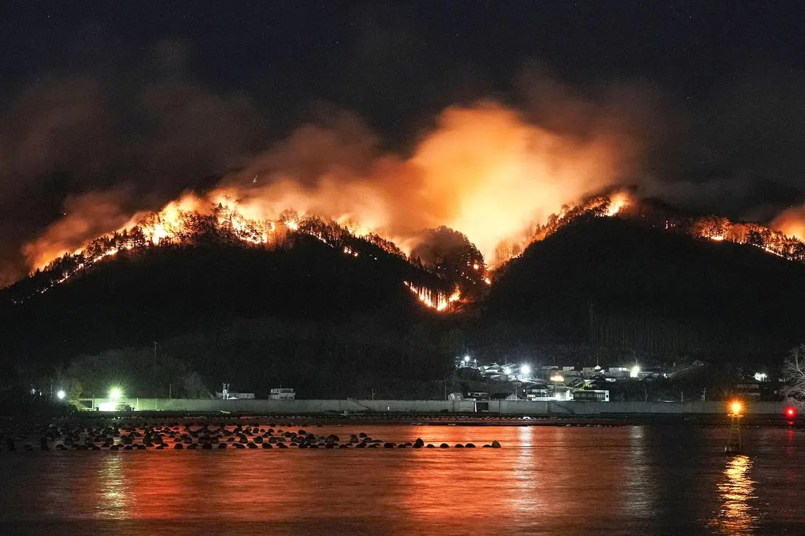 A wildfire continues to rage in a mountainous area in Ofunato, Iwate Prefecture, northeastern Japan, March 3, 2025, in this photo taken by Kyodo. Mandatory credit Kyodo/via REUTERS ATTENTION EDITORS - THIS IMAGE HAS BEEN SUPPLIED BY A THIRD PARTY. MANDATORY CREDIT. JAPAN OUT. NO COMMERCIAL OR EDITORIAL SALES IN JAPAN.