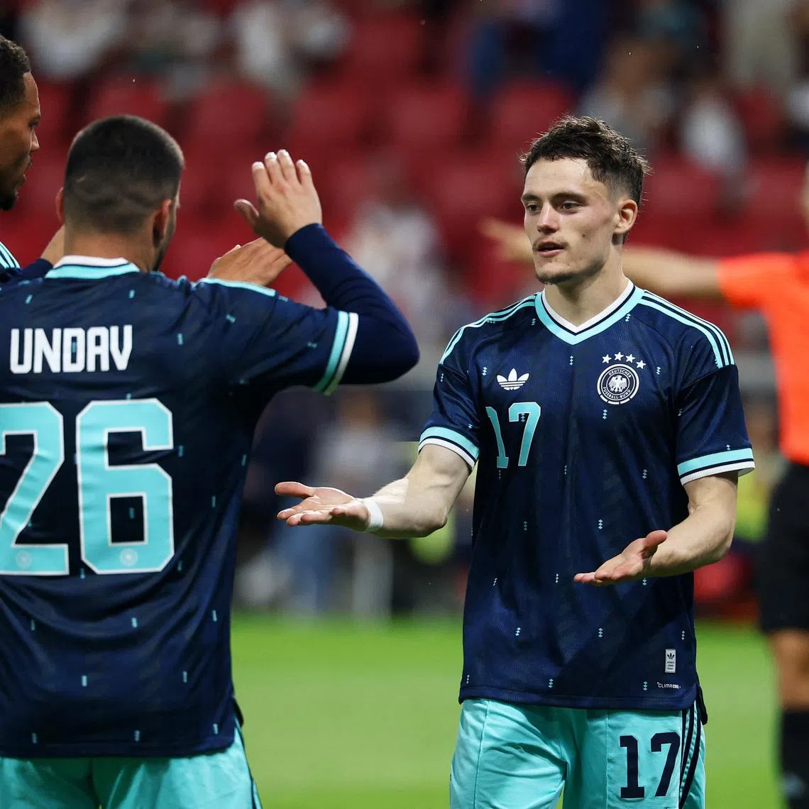 Soccer Football - International Friendly - Germany v Finland - MEWA Arena, Mainz, Germany - May 31, 2026 Germany's Florian Wirtz celebrates scoring their second goal with Felix Nmecha and Deniz Undav REUTERS/Kai Pfaffenbach