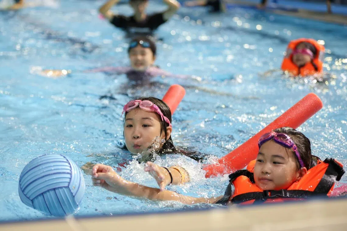 Children playing water polo at The Kallang’s June holiday aquatics camp at the OCBC Aquatic Centre.